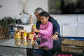 Senior woman with granddaughter playing at table in living room
