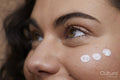 Close-up of young woman applying face cream
