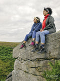 Female hikers sitting on rocks and looking at landscape