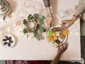 High angle view of women reaching for sweet snack on table
