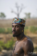 Portrait of young shirtless man wearing traditional hat