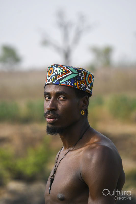 Portrait of young shirtless man wearing traditional hat