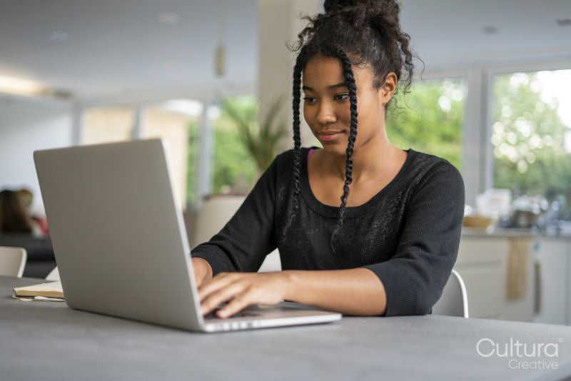 Teenage girl using laptop
