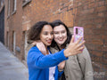 Smiling couple taking selfie on street