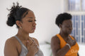 Women practicing pranayama in yoga studio