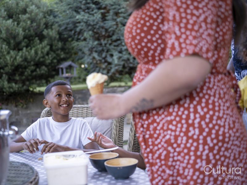 Mother preparing ice cream for children