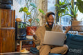Man sitting on sofa and using laptop