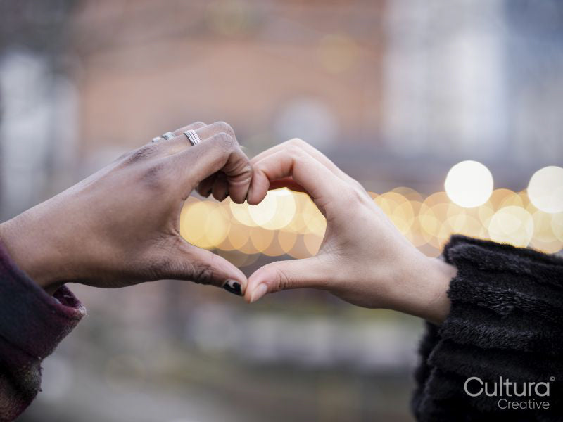 Close-up of hands making heart sign