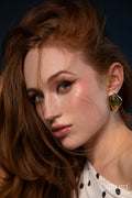 Studio portrait of a woman in a polka dot top with windswept hair