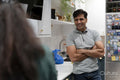 Happy man standing in kitchen