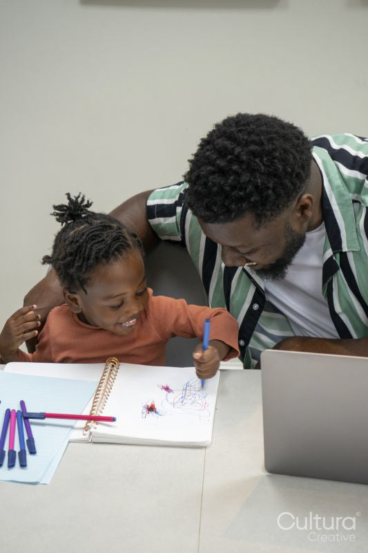 Father and daughter drawing together in notepad