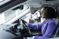 Confident woman driving car