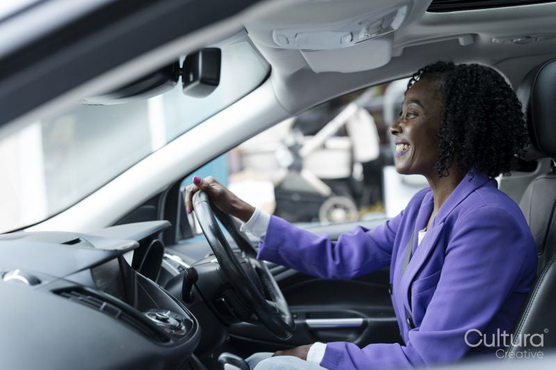 Confident woman driving car