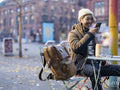 Man using smart phone while sitting at sidewalk cafe