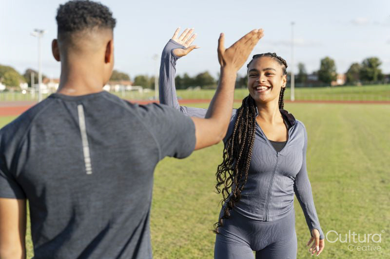 Couple of athletes doing high five