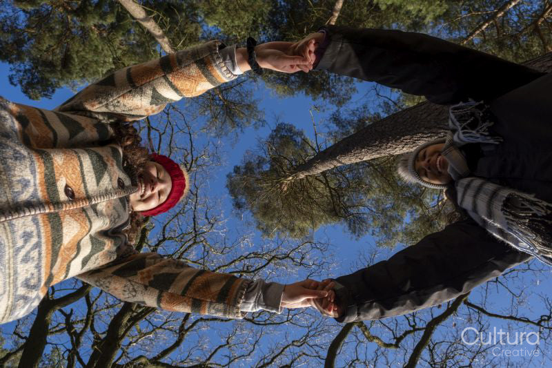 Low angle view of female friends holding hands