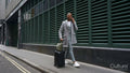Business man pulling suitcase
