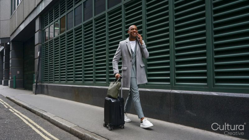 Business man pulling suitcase
