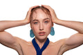Studio portrait of a woman in a blue dress and large blue earrings