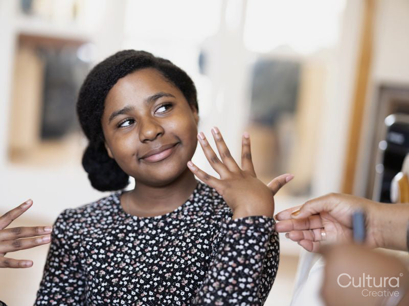 Daughter showing mother painted nails