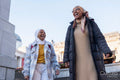 Young female tourists in hijabs walking around city