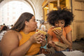 Two young women eating street food