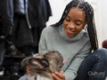Smiling woman stroking dog at home
