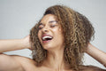 Studio portrait of smiling woman with curly hair