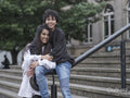 Female couple hugging on stairs in city
