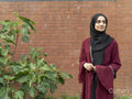 Woman wearing hijab standing in backyard