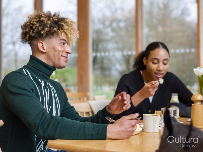 Young man and woman sitting in cafe