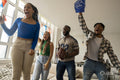 Excited friends watching sport game on TV at home