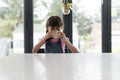 Little girl drinking from mug at table