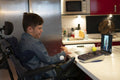 Disabled son talking with father on laptop through video call
