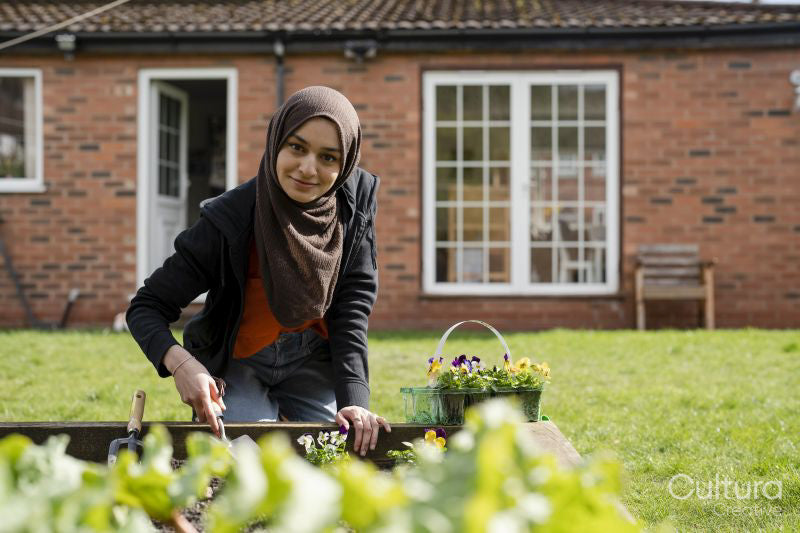 Woman wearing hijab working in garden