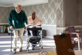 Smiling senior people using mobility walker and cane