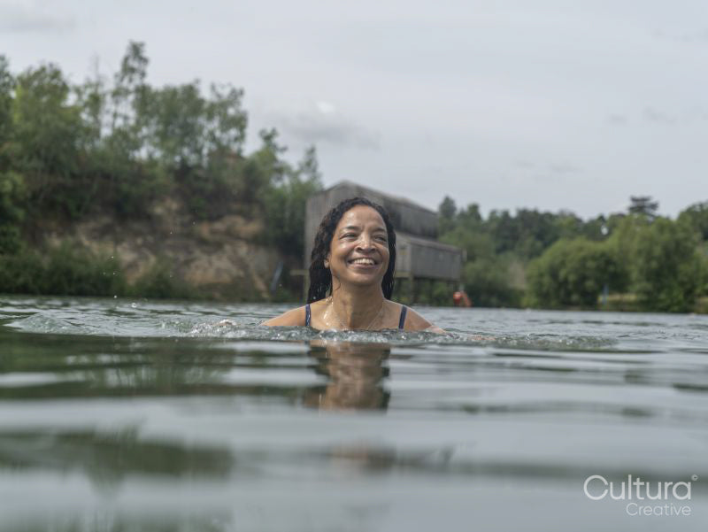 Smiling woman swimming in lake