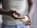 Close-up of person holding jar of moisturizer