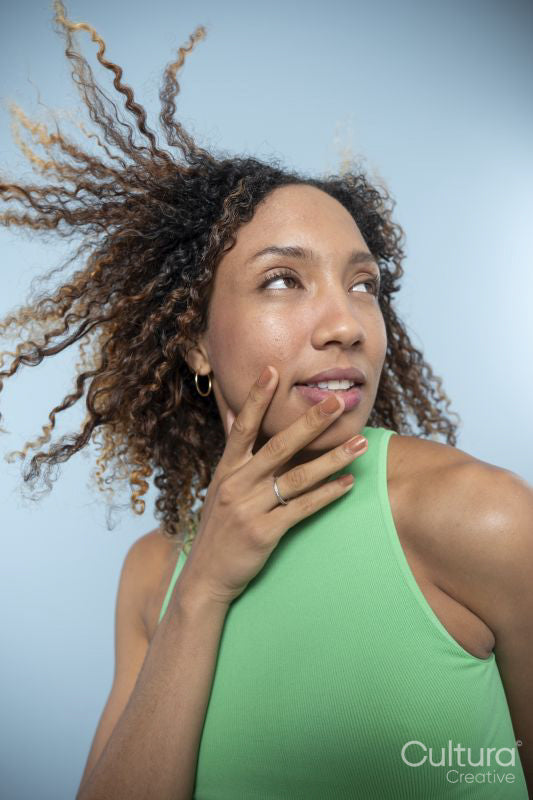 Portrait of woman with curly hair and green top