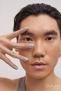 Studio portrait of handsome man with colored nails