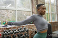 Athletic woman exercising with resistance band at gym