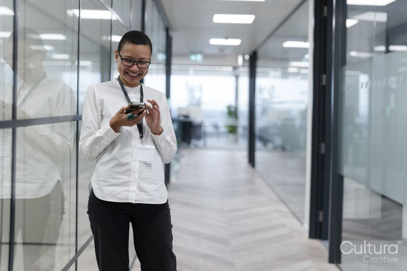 Non binary office worker standing in corridor