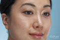 Close-up of woman's face against blue background