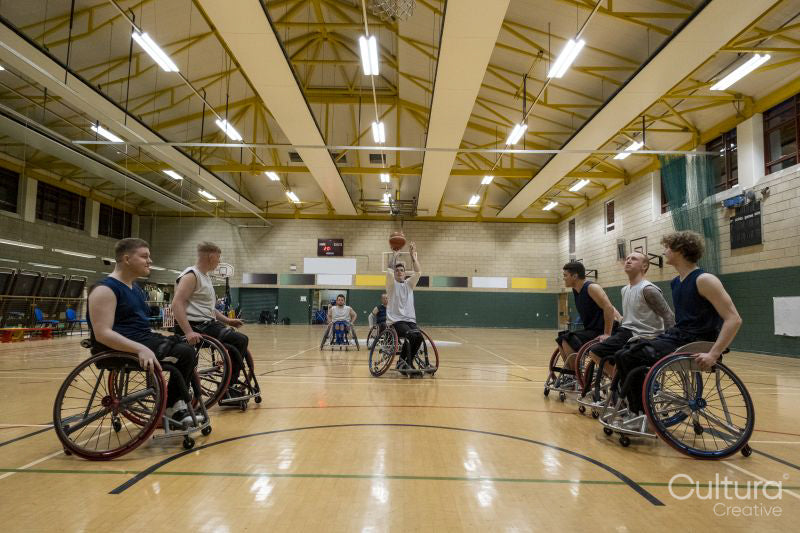 Man in wheelchair doing free throw during match