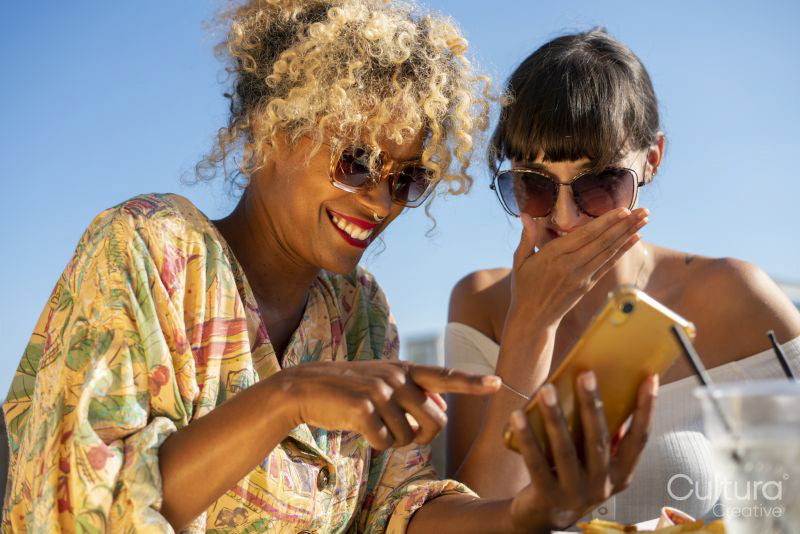 Female couple looking at phone