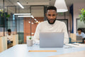 Young man working on laptop in office