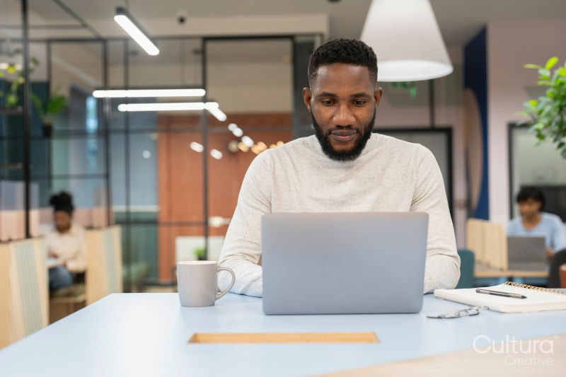 Young man working on laptop in office