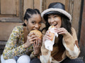 Two young women eating fast food
