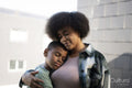 Smiling mother and son hugging