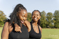 Young female friends walking in park after exercising